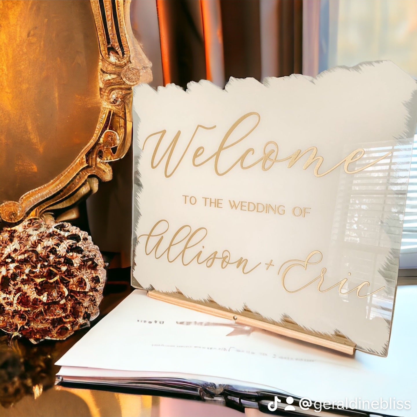 Decorative pillow with 'Welcome to the wedding of Allison & Eric' text on a reflective surface.