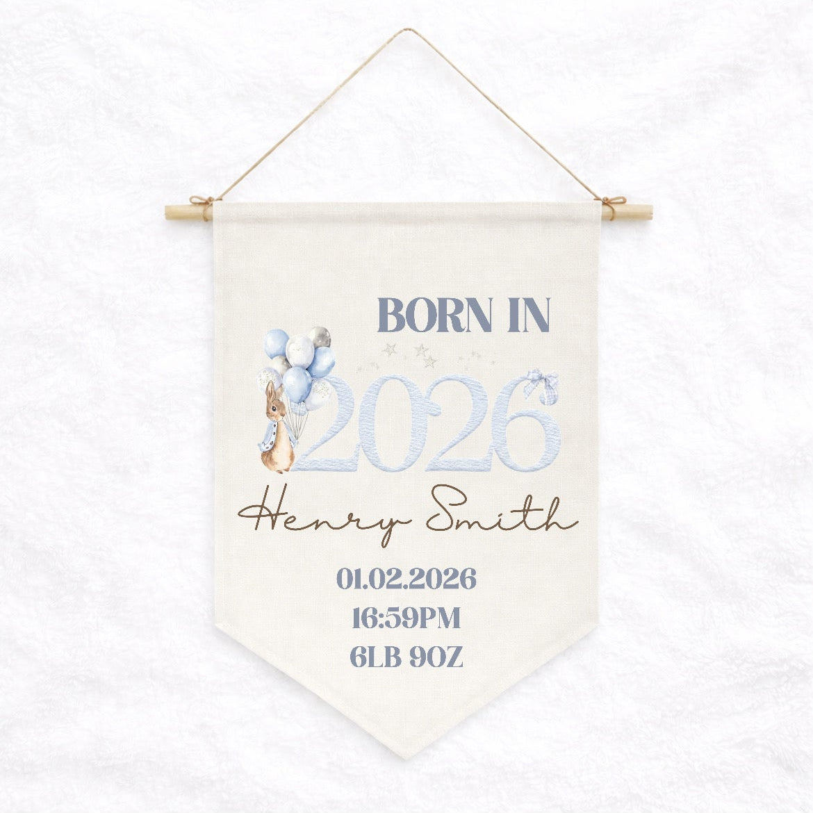Decorative banner with text 'Born in 2026' and baby details on a white background