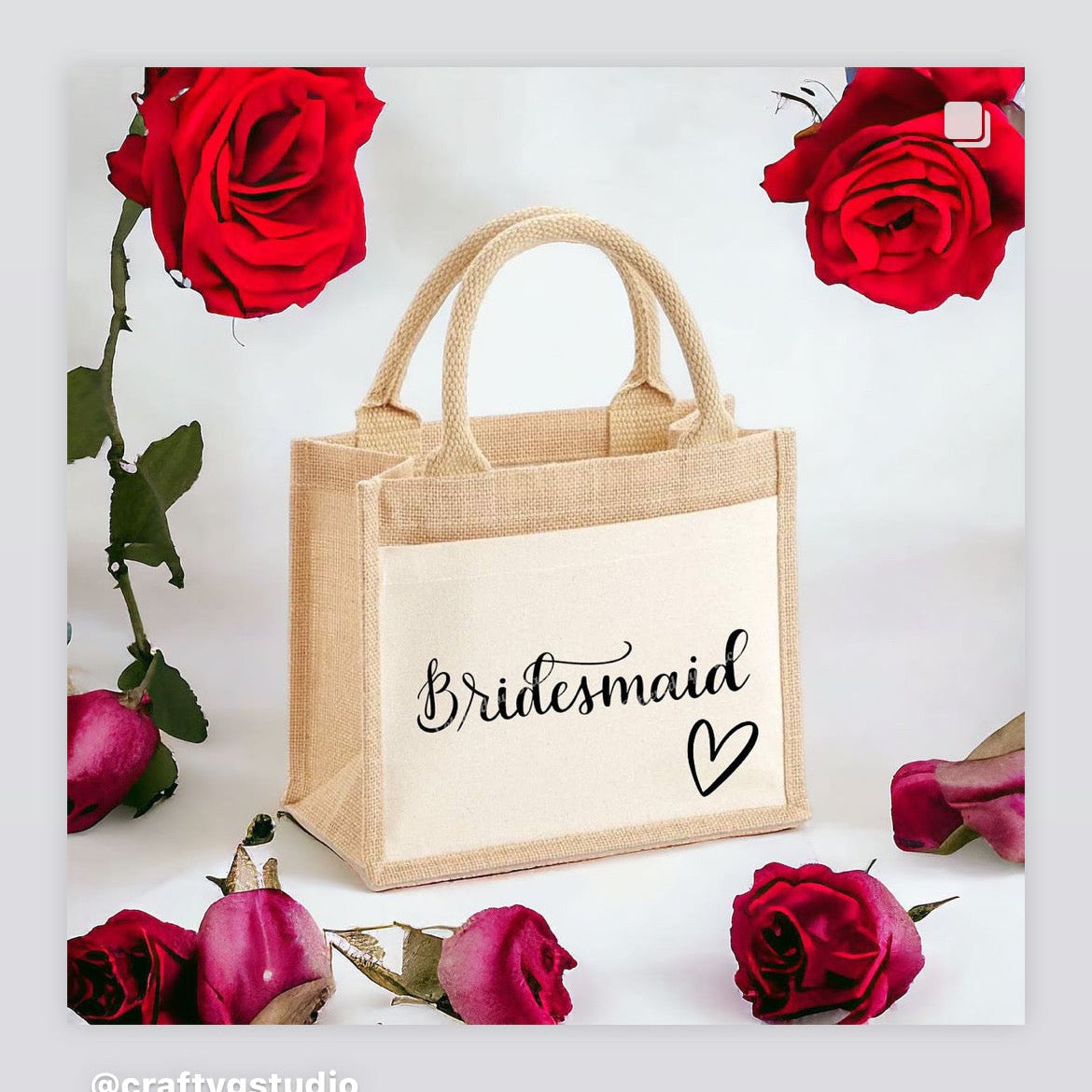 Beige tote bag with 'Bridesmaid' text surrounded by red roses on a white background