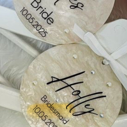 Personalized coasters with names and dates on a white surface