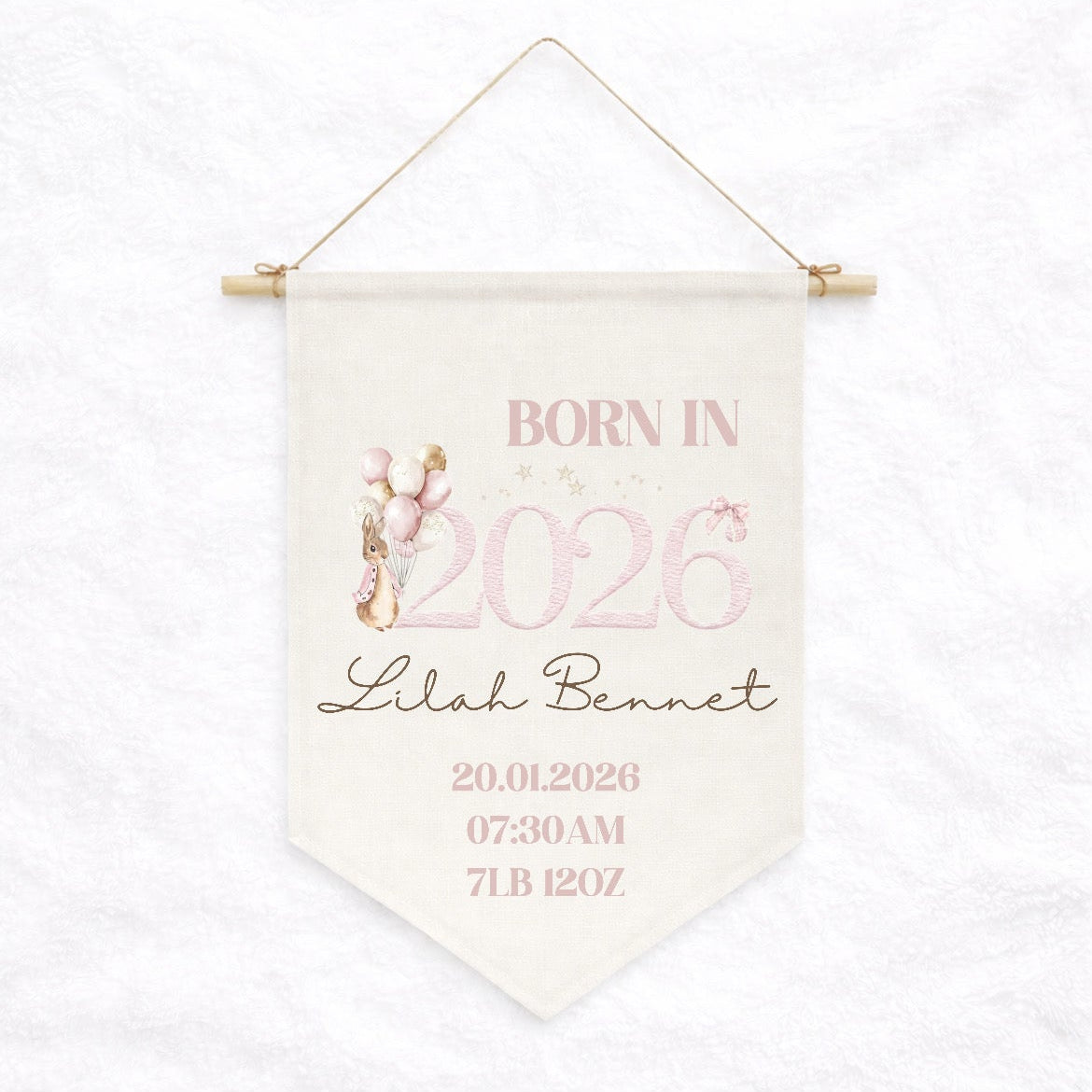 Personalized birth announcement banner with baby's name and birth details on a white background
